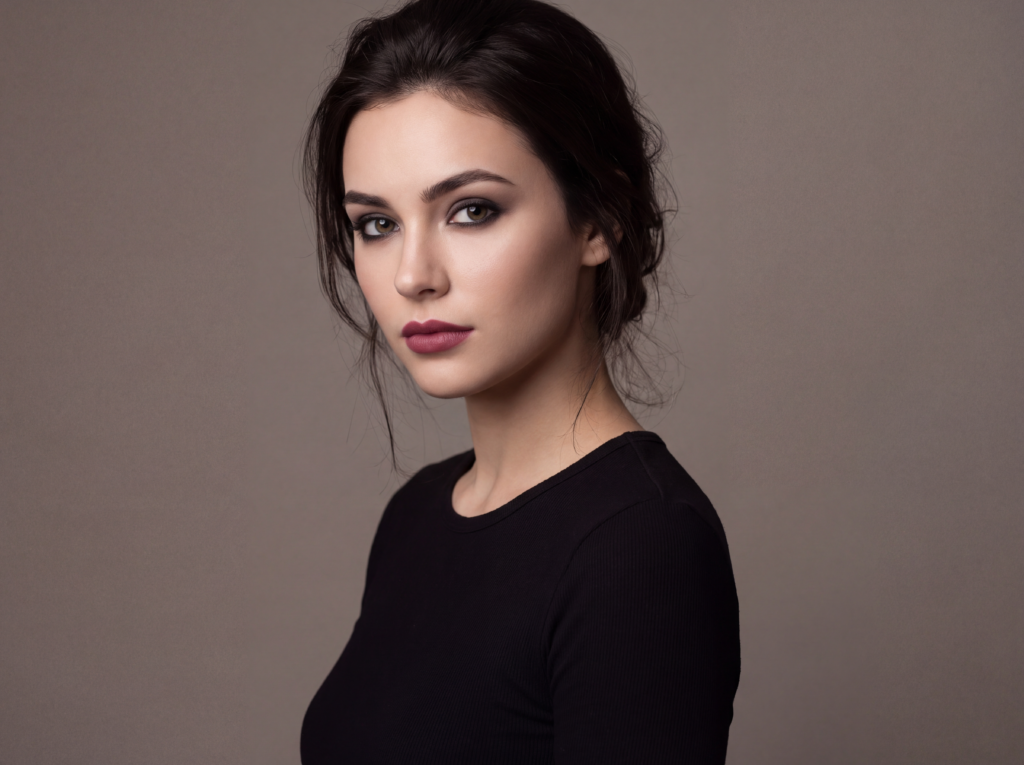 Woman wearing beginner-friendly gothic makeup with soft smoky eyes and a muted berry lip